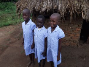 Children wearing gifts of school dresses brought by one of the volunteers © Penny Cook