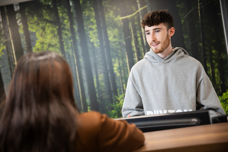 a man working behind a desk in a centre