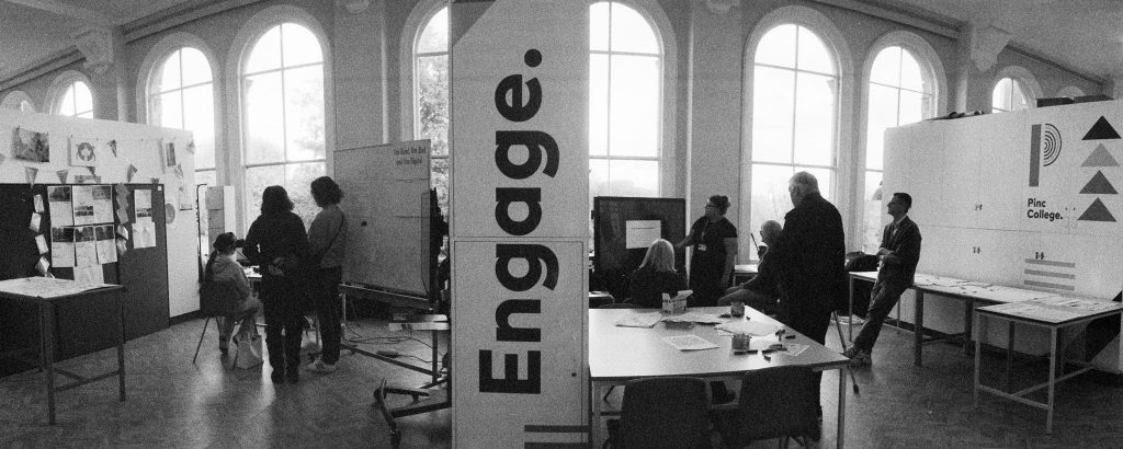 Black and white image of people engaging with different tasks, including virtual reality and the escape room. Picture taken by Nabil Hasshim