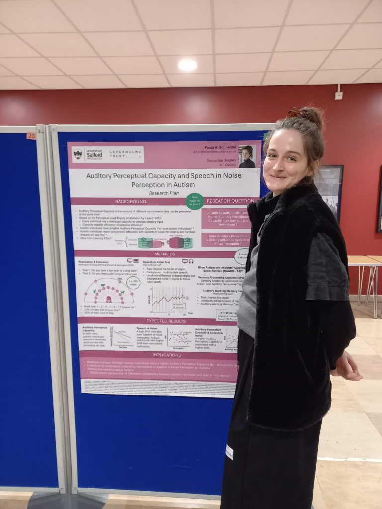 Paula standing next to her research poster