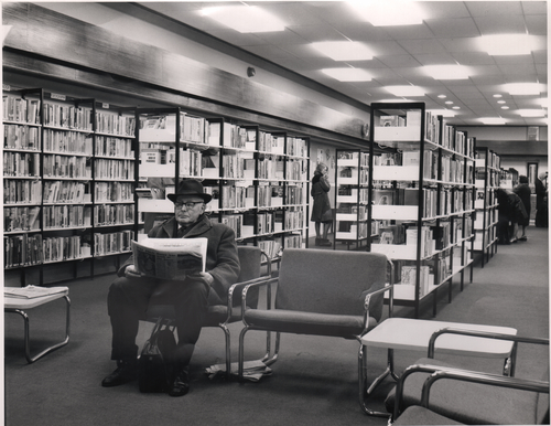 Man reading newspaper in Broughton District Library, 1975. Salford Local History Library. Reference Number: AG00008.