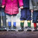 Group of children holding hands outside