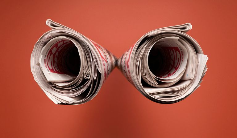 Two newspapers rolled up next to each other.