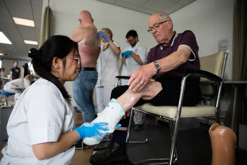 a student helping with prosthetics and orthotics