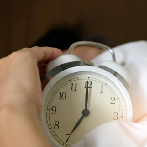 An Alarm Clock wakes up a person