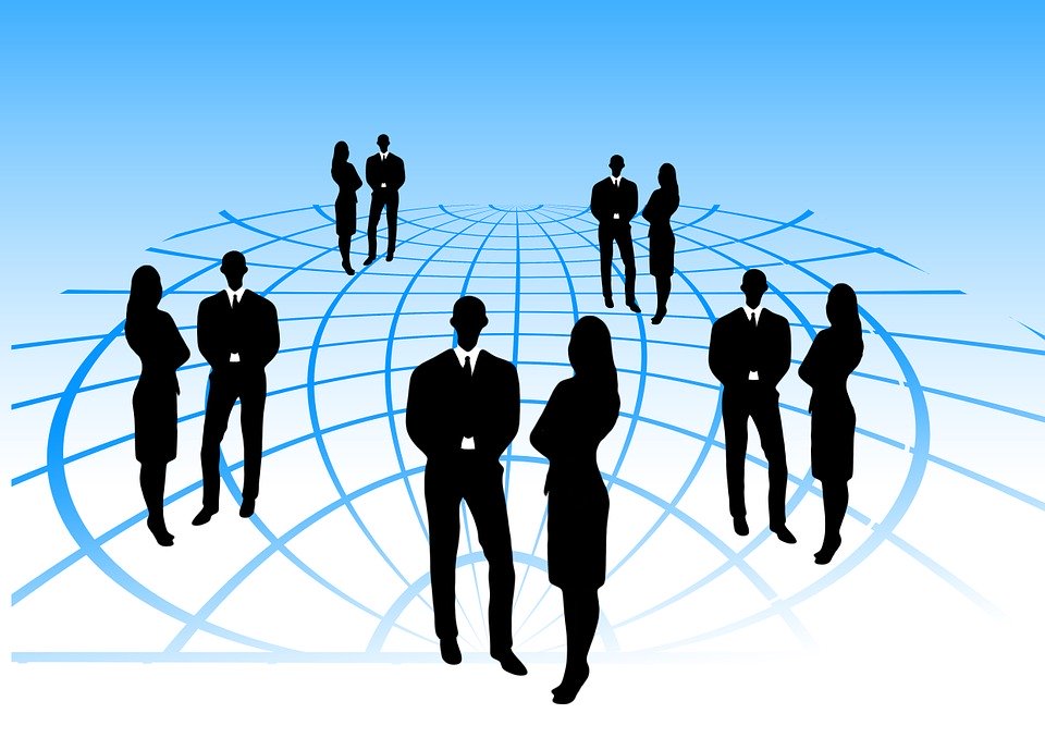 Shapes of people standing on a grid, representing networking and teamwork.
