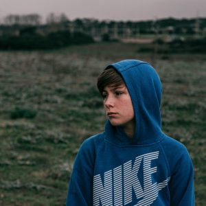 boy wearing blue hoodie outside