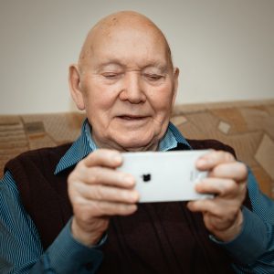 old man looking at a phone