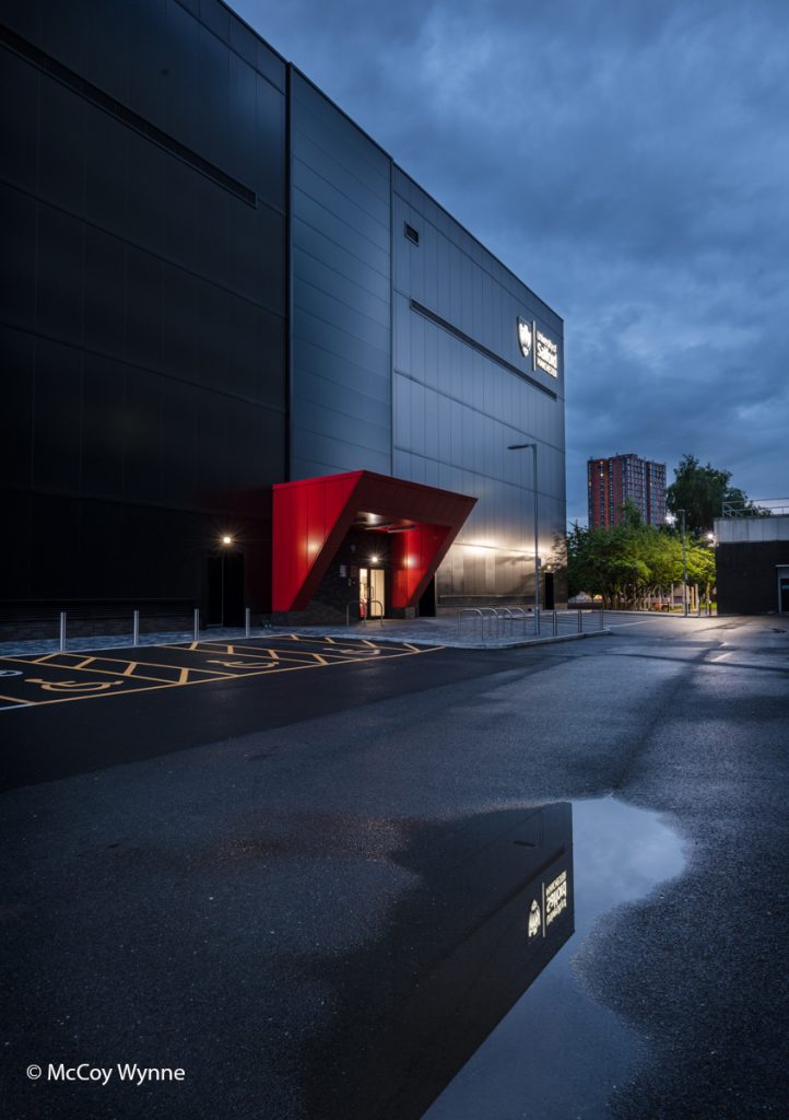 Side view picture the energy lab building in the evening light after rain . The sky looks dark and cloudy.